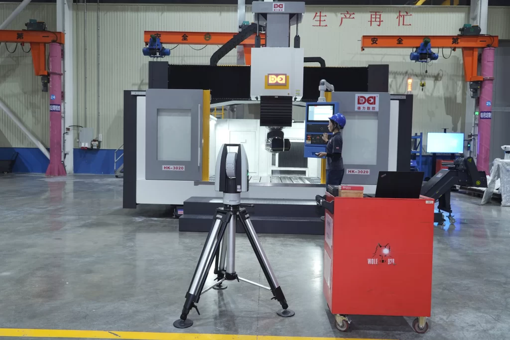 Automated CNC machining facility: Operator monitors large-scale production with high-precision measurement equipment, ensuring micron-level accuracy and quality control in precision engineering.