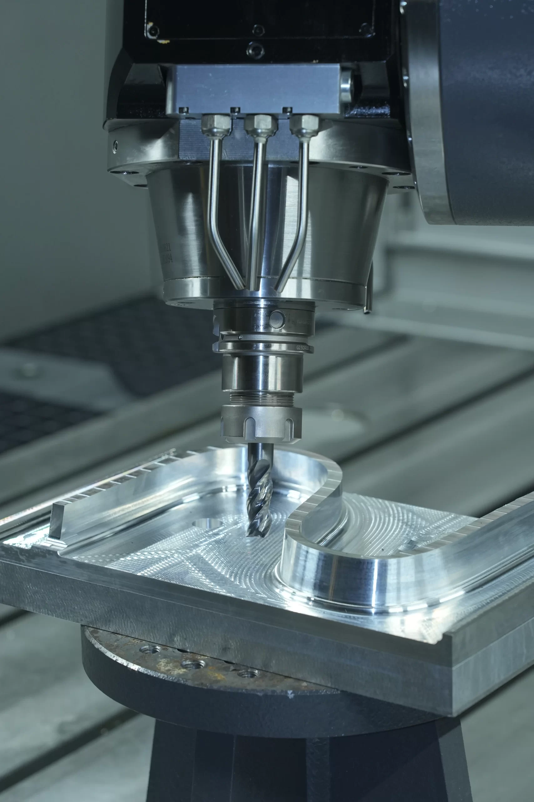 High-magnification view of CNC milling operation on aluminum alloy component. Highlights micro-precision cutting with spiral tool, achieving smooth surface finish and complex contours (±0.01mm tolerance). Ideal for aerospace/medical industry parts requiring tight geometric accuracy.