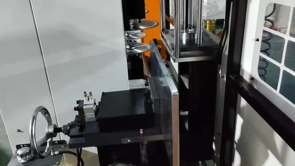 Close-up of the details of the workpiece clamping and manual adjustment of the positioning accuracy of the handwheel on the milling machine workbench