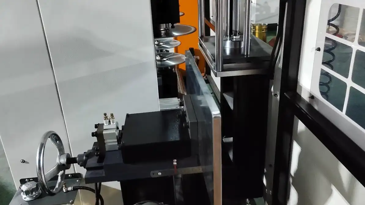 Close-up of the details of the workpiece clamping and manual adjustment of the positioning accuracy of the handwheel on the milling machine workbench