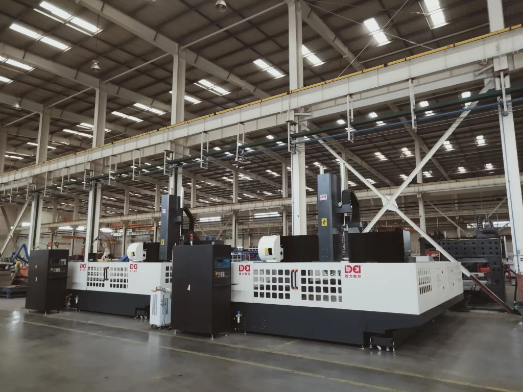 Wide-angle view of a spacious industrial factory workshop featuring DEI large CNC gantry machining centers (model identifiable by “DEI” branding). These high-precision machines are engineered for heavy-duty metal processing (e.g., aluminum, steel), supporting large-scale production of complex components (aerospace frames, automotive molds, energy industry parts).
