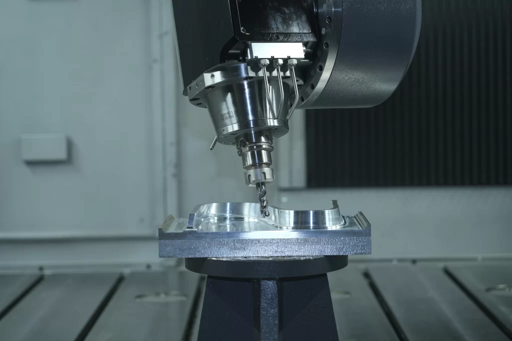 Close-up of CNC milling machine cutting aluminum component with micron-level precision – illustrating repeatability and GD&T compliance for aerospace and automotive parts.