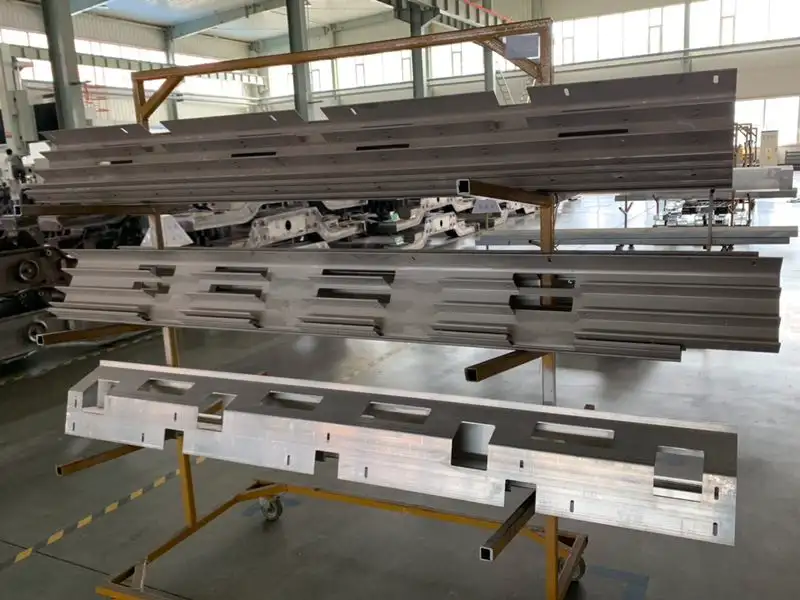 Aluminum CNC machined parts organized on a storage rack in a factory, showcasing precision milled industrial components