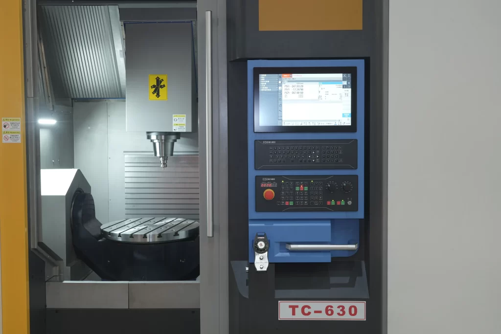 A CNC machining center’s control panel displays G-code for path programming and M-code for auxiliary settings, illustrating integrated control over machining processes.