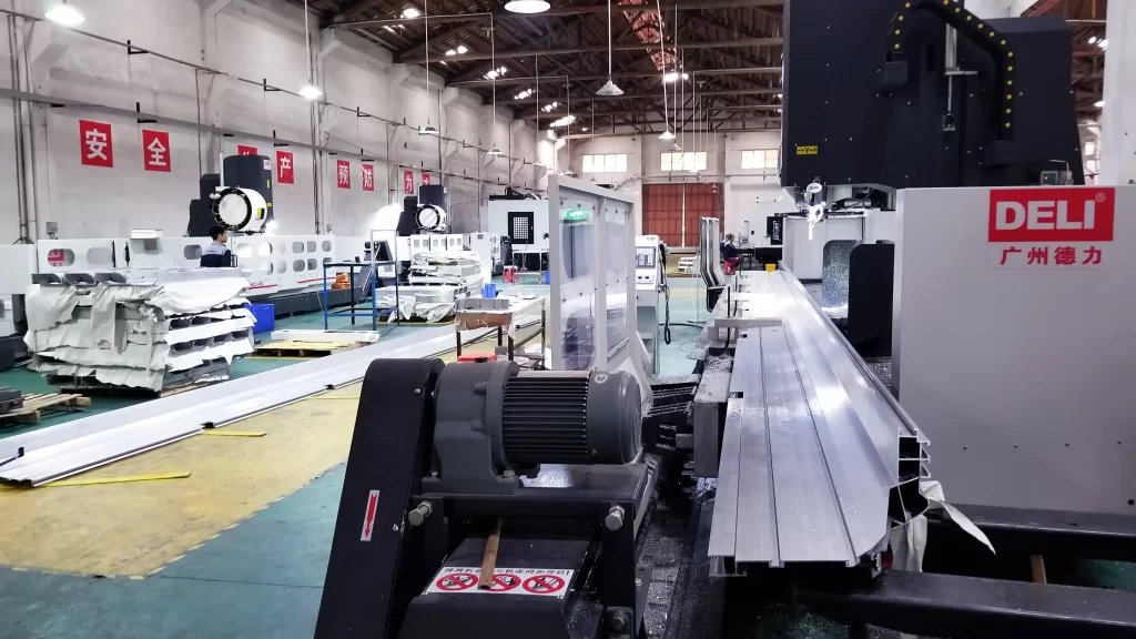 Large CNC machining center operating in a factory, showcasing automated metal-processing equipment for industrial manufacturing.