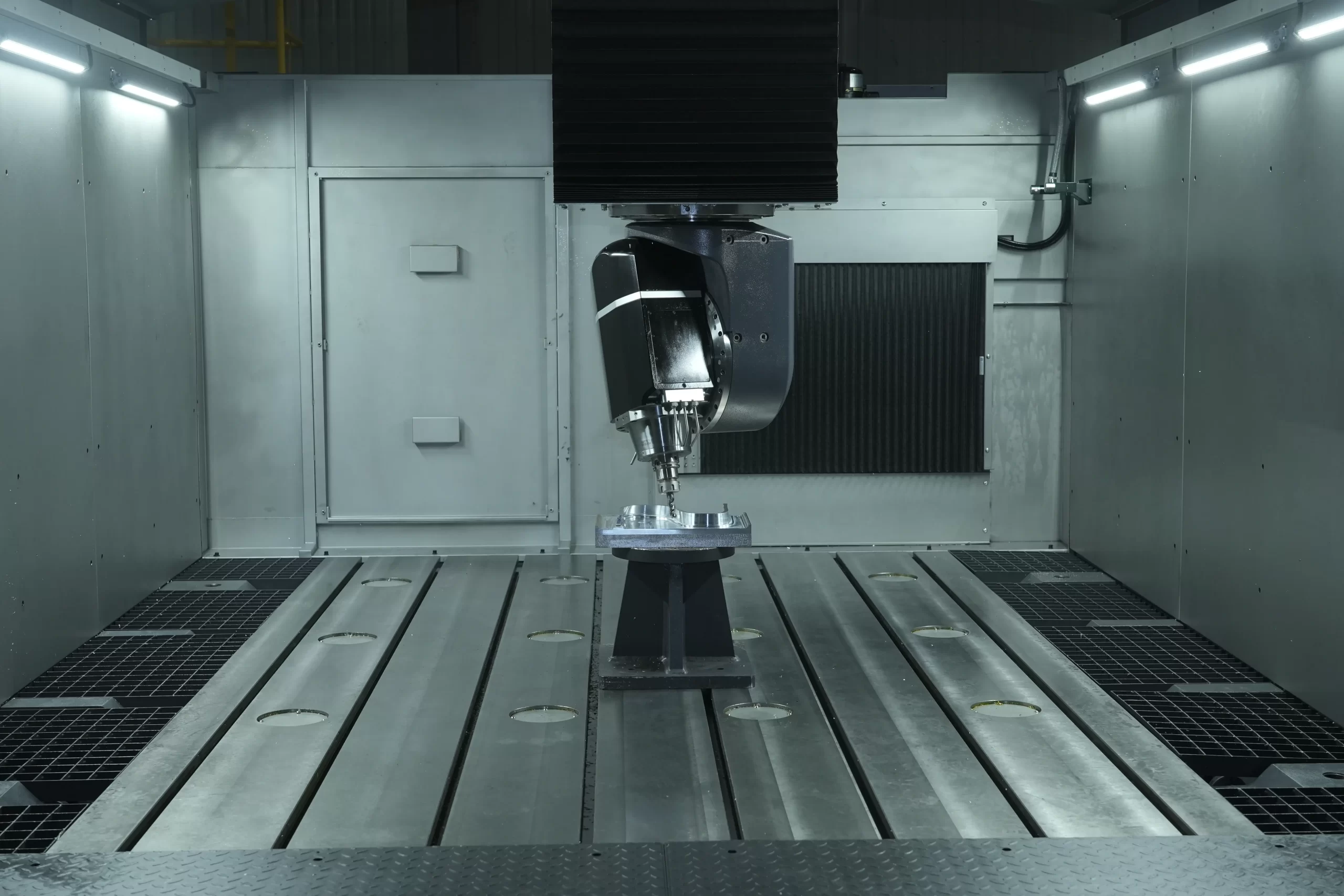 A high - precision 5 - axis CNC machining center in operation. The spindle and cutting tool are aligned with the workpiece, demonstrating multi - axis linkage for machining complex curved parts, applicable to precision manufacturing like aerospace and automotive industries.