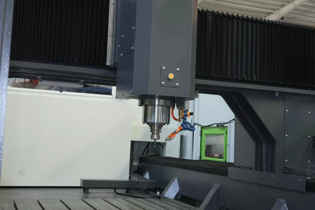 A close-up of a CNC machining center’s spindle head, featuring advanced coolant lines and a precision milling tool. The robust, industrial design highlights capabilities for high-accuracy cutting in sectors like aerospace or 5G component manufacturing.