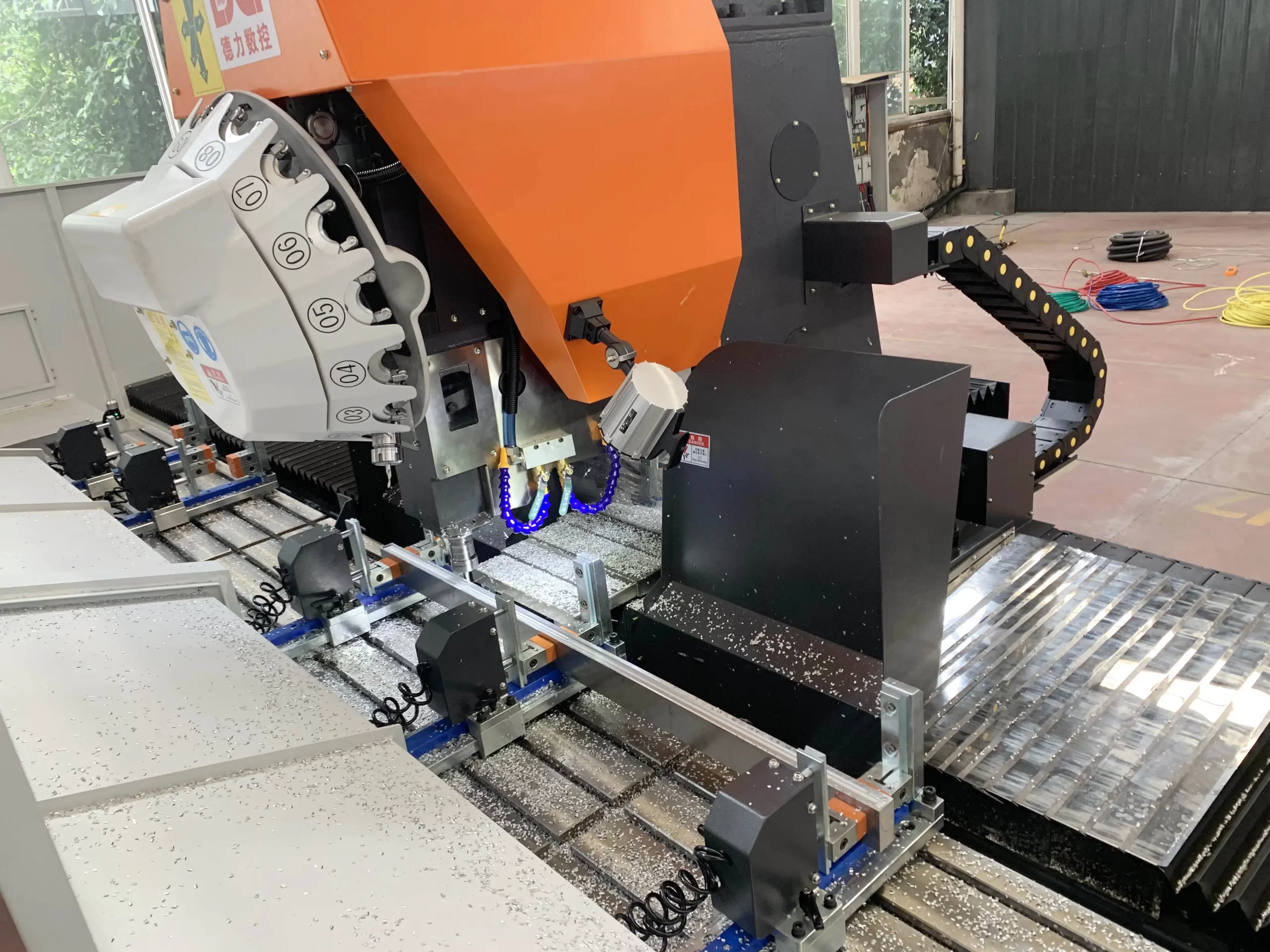 Close - up of a metal CNC machine cutting aluminum, with coolant and metal shavings, illustrating high - precision metal machining processes enabled by advanced CNC technology.