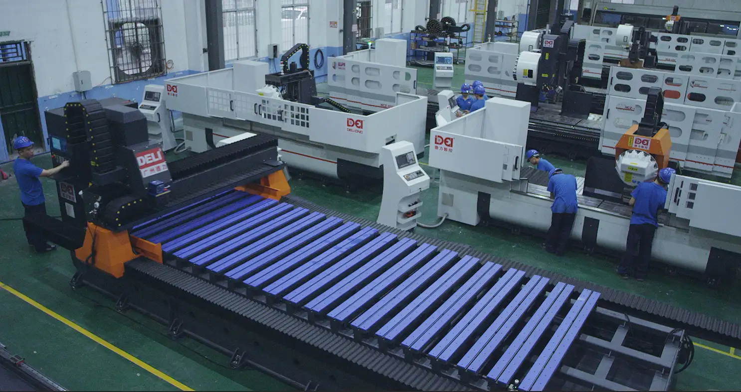 Factory floor with multiple CNC machines and workers operating equipment, indicating a busy manufacturing environment.